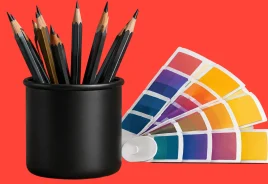 Pencils in a holder next to a color palette, illustrating how strategic, result-driven design powers your business.